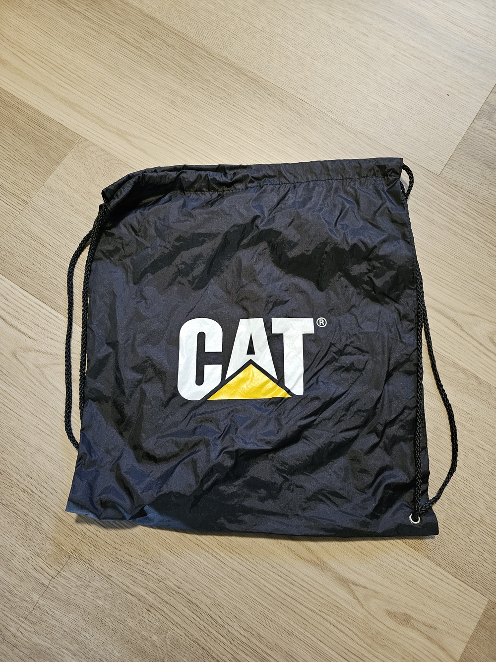CAT Logo Black Drawstring Backpack with Yellow Accent